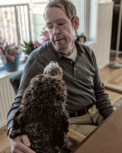 Peter plays with a therapy dog